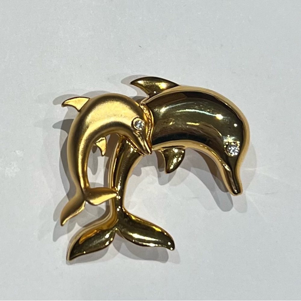 Vintage gold tone Dolphin pair (adult and child) brooch with rhinestone eyes.